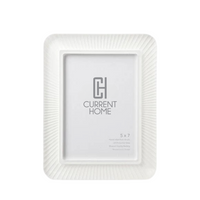 The Bella Moulding Rays Frame Snow White is a hand-crafted rectangular frame with a textured, radiating border, designed to fit a 5 x 7 inch photo—perfect for complementing modern decor.