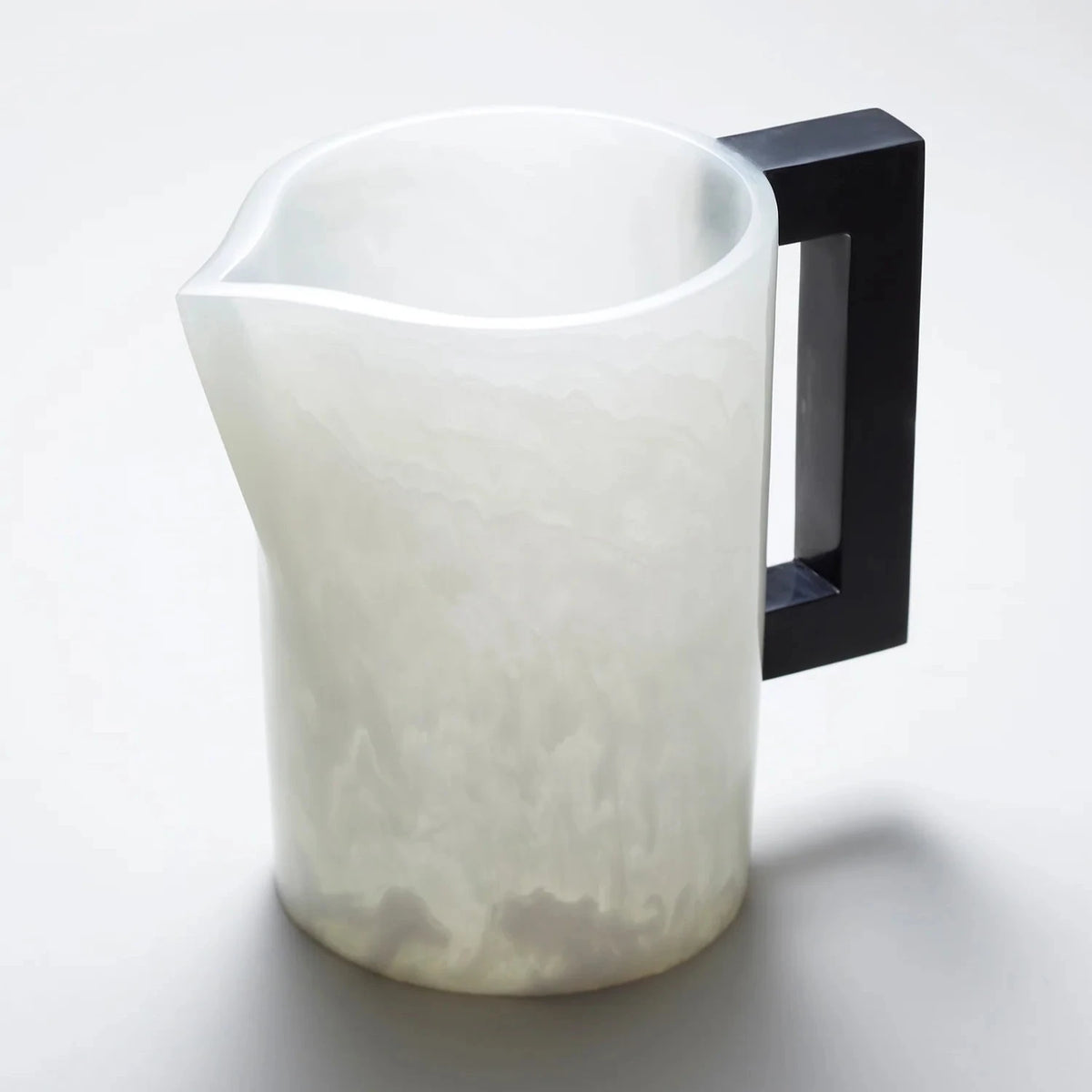 The Pearl's Pitcher White with Charcoal Handle by Lily Juliet features a translucent white resin body, matte finish, wide spout, and large black handle. Perfect for serving drinks at dinner parties; shown against a light background.