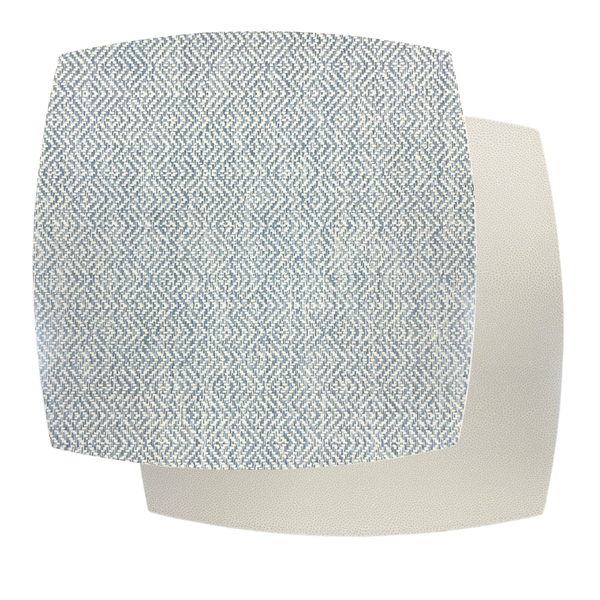 Two overlapping fabric swatches: the top features a blue and white geometric zigzag pattern, inspired by the Ellipse Reversible Placemat Set of 4 - Azure Eggshell by Julian Mejia, layered over a plain off-white textured swatch beneath.