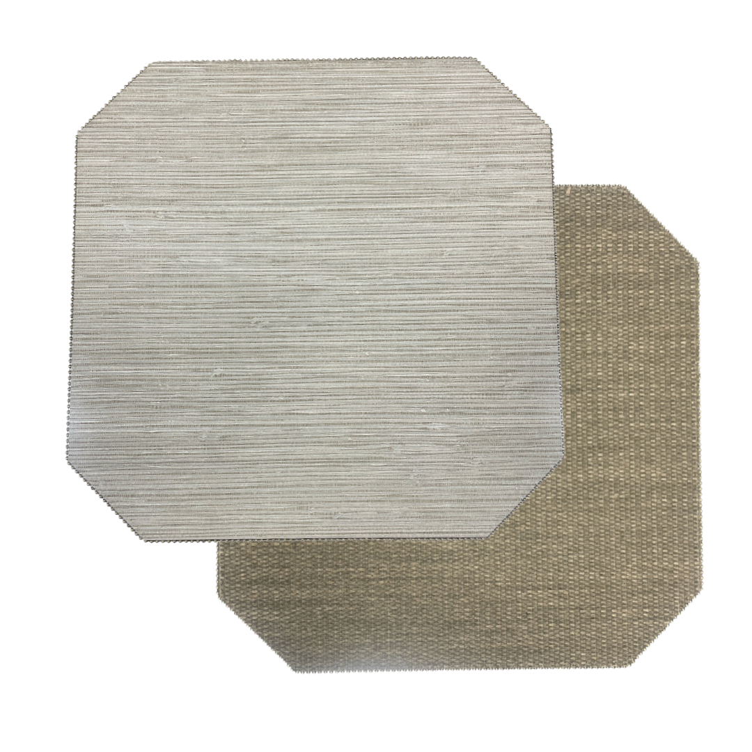 Two rectangular Julian Mejia Reversible Cut Corner Placemats from the Calia/Timber set are overlapping on a white background—one in light gray (Calia), the other in tan (Timber). Both feature a subtle striped texture and chamfered corners, accentuating their elegant design.