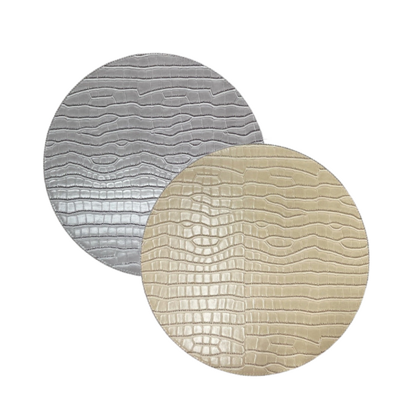 The Julian Mejia Beads Round Reversible Placemat Set of 4 in Hydrangea & Vanilla features stylish round mats with a chic texture, shown overlapping against a white background to enhance any table setting.