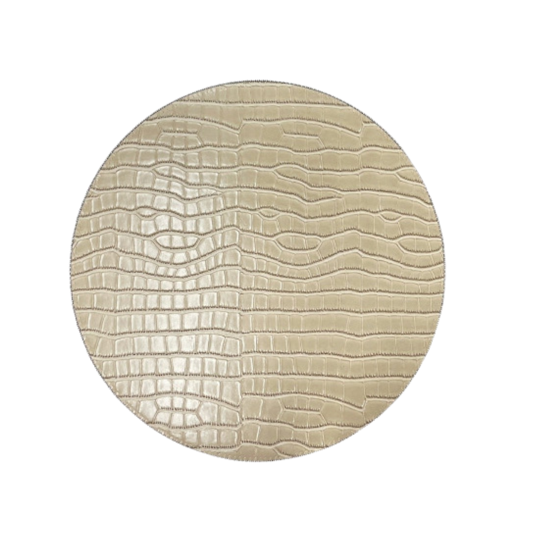 The Julian Mejia Beads Round Reversible Placemat Set of 4 in Hydrangea & Vanilla features a textured, crocodile-like pattern on beige hardboard, displayed against a white background.