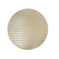 The Julian Mejia Beads Round Reversible Placemat Set of 4 in Hydrangea & Vanilla features a textured, crocodile-like pattern on beige hardboard, displayed against a white background.