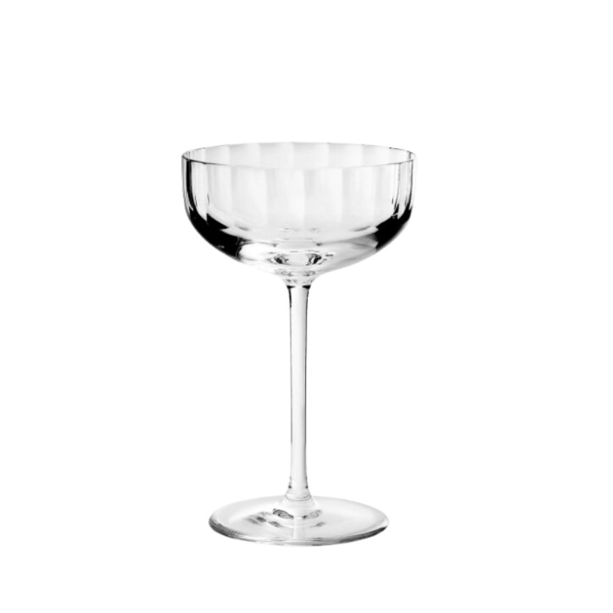 The Richard Brendon Fluted Coupe is a clear, mouth-blown glass with a wide, shallow bowl and long stem from the Fluted Collection, shown empty against a white background.