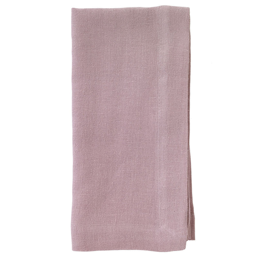 The Bodrum Riviera Napkin Set of 4 features rectangular, light mauve, stone-washed linen napkins with a subtle woven texture, neatly folded and displayed on a white background.