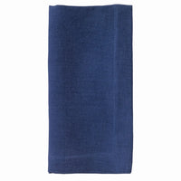 The Bodrum Riviera Napkin Set of 4 features neatly folded, rectangular dark blue stone-washed linen napkins displayed on a plain white background.