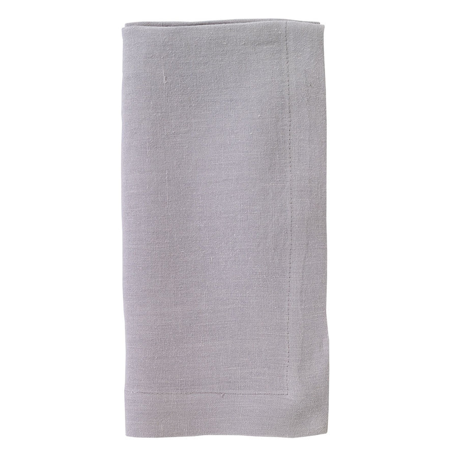 The Bodrum Riviera Napkin Set of 4 features neatly folded, light gray stone-washed linen napkins with a simple stitched border, displayed on a white background.
