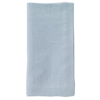 The Bodrum Riviera Napkin Set of 4, featuring light blue stone-washed linen, is neatly folded and displayed against a white background.