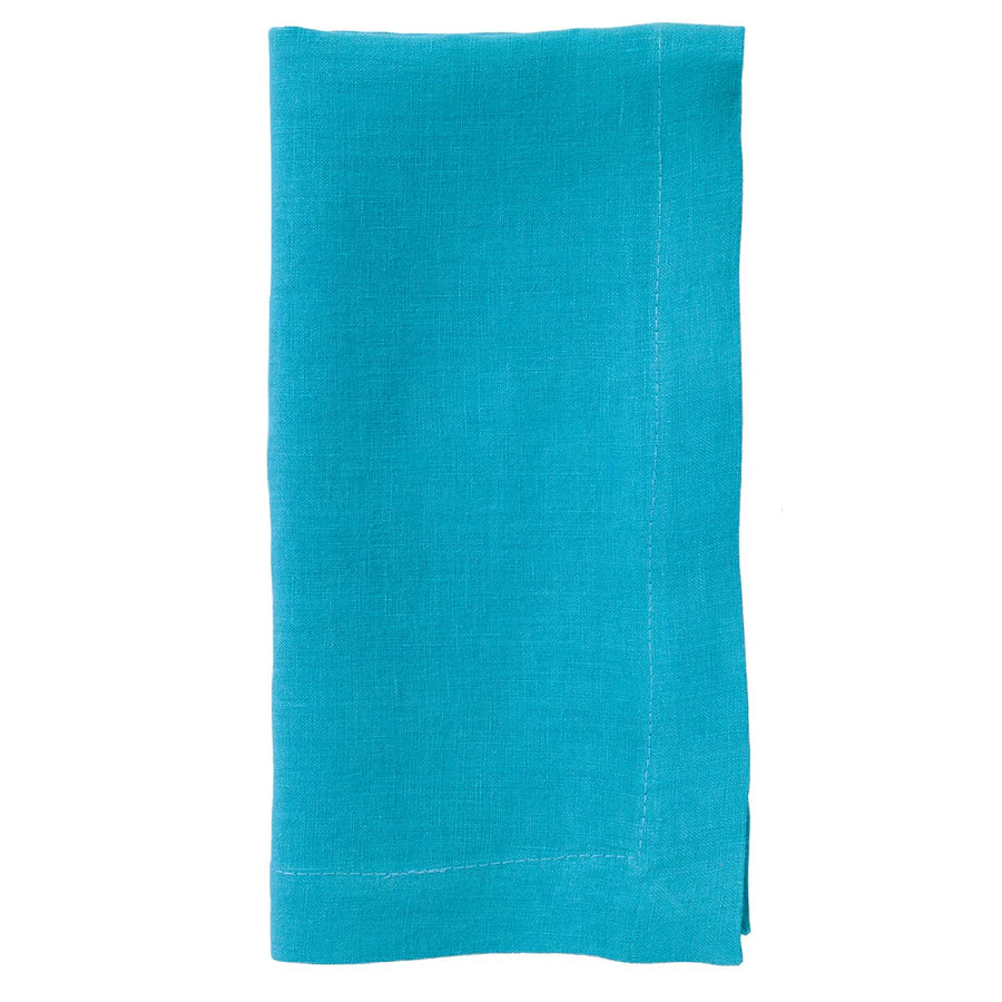 The Bodrum Riviera Napkin Set of 4 features neatly folded turquoise stone-washed linen napkins with visible edge stitching, shown on a white background.