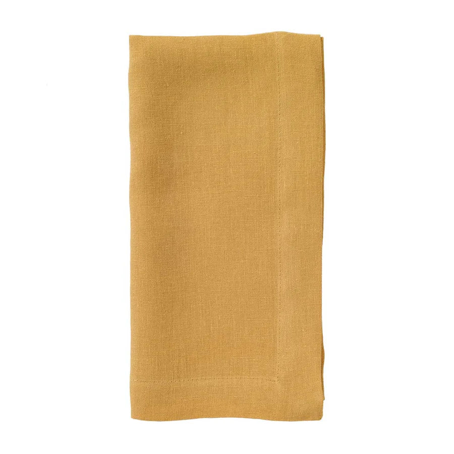 The Bodrum Riviera Napkin Set of 4 features mustard yellow stone-washed linen napkins with stitched edges, neatly folded and displayed on a white background.