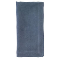The Bodrum Riviera Napkin Set of 4 features neatly folded, rectangular blue stone-washed linen napkins with a subtle textured pattern, displayed on a white background.