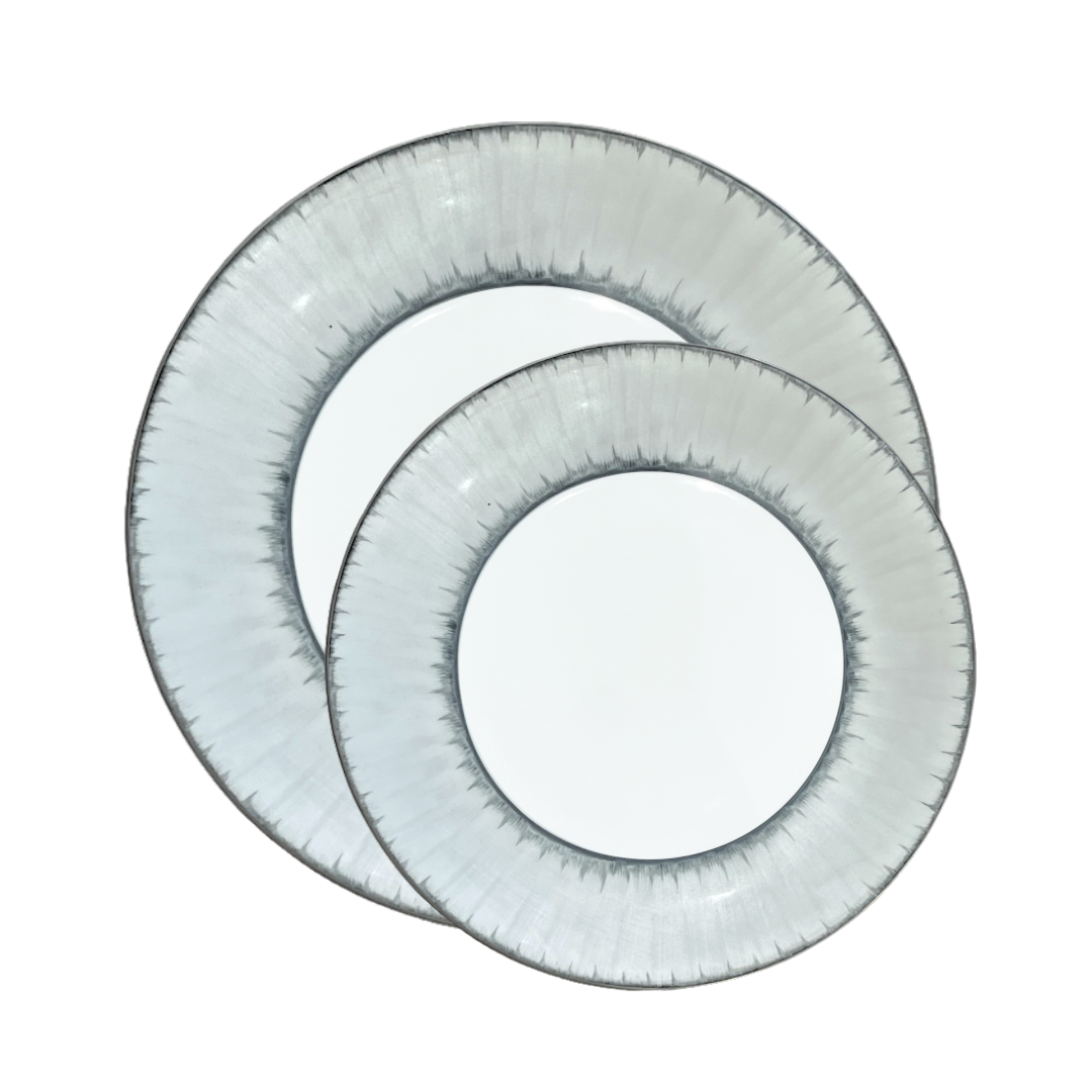 Two round, translucent plates with a textured platinum rim overlap each other on a white background—an exquisite example of Marie Daâge Ruban Dinnerware Platinum Rim, hand-painted from fine Limoges porcelain.