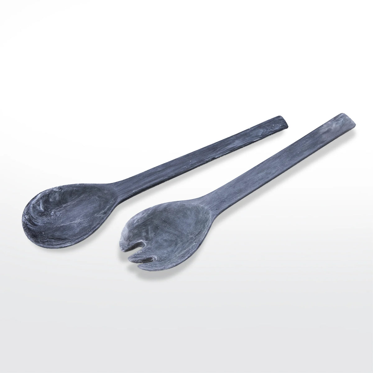 The Swirl Resin Classic Everyday Salad Server Set by Nashi Home features two handcrafted servers—one spoon and one forked spork—in dark gray resin with a marbled texture and modern, minimalist design, shown on a white background.