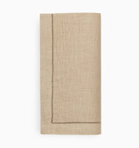 The Sferra Festival Napkin Set of 4 features neatly folded beige European linen napkins with decorative stitched borders, displayed on a plain white background.