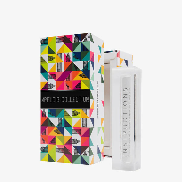 A colorful, geometric-patterned Apeloig Collection box stands beside a clear rectangular case labeled "INSTRUCTIONS," displaying the Modern Acrylic Mezuzah Case 4.5", all set against a white background.