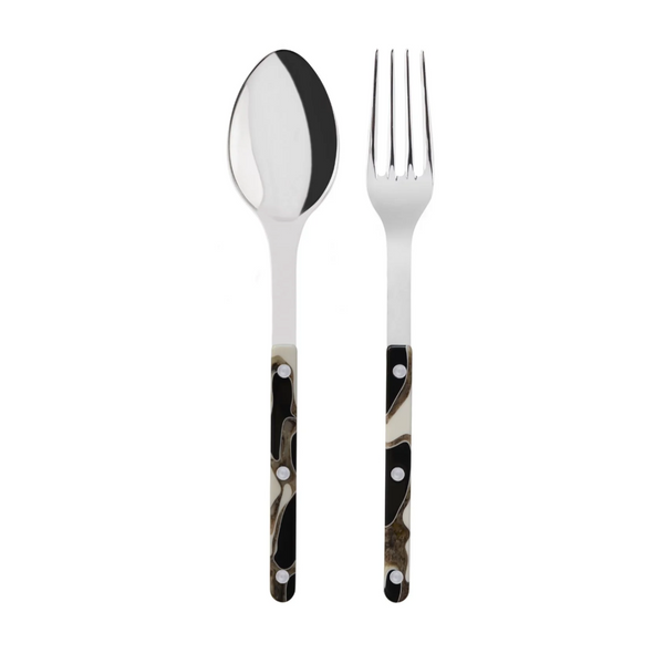 The Sabre Bistro Dune Salad Set includes a metal spoon and fork with polished 18/10 stainless steel tops and handcrafted acrylic handles in a black, white, and brown abstract pattern with silver rivets.