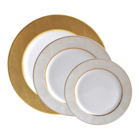 Three round Bernardaud Sauvage Gold Dinnerware plates overlap on a white background; the largest has a wide gold rim, while two smaller Limoges porcelain plates feature thinner gold borders.