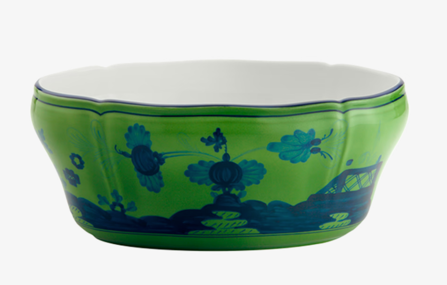 The Oriente Italiano Dinnerware Malachite by Ginori 1735 is a green porcelain bowl with a scalloped rim, featuring blue floral and landscape designs and a plain white interior—an elegant nod to classic Italian style.