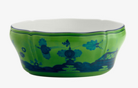 The Oriente Italiano Dinnerware Malachite by Ginori 1735 is a green porcelain bowl with a scalloped rim, featuring blue floral and landscape designs and a plain white interior—an elegant nod to classic Italian style.