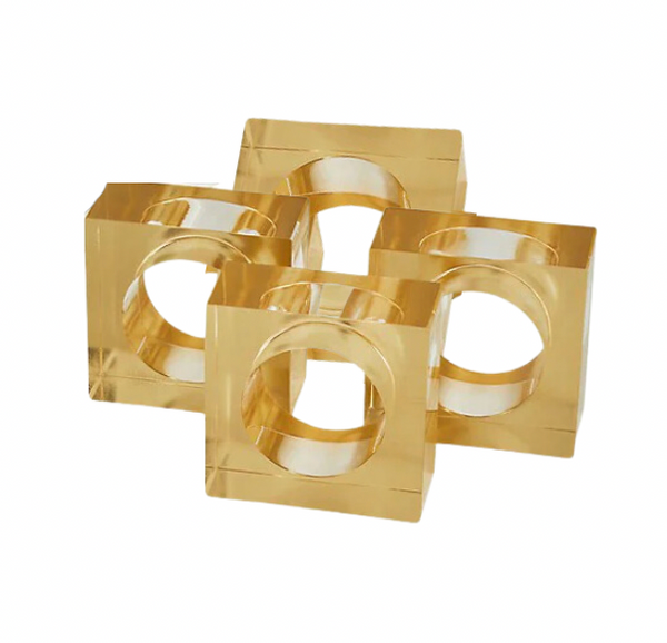 The Tizo Lucite Cube Napkin Ring Set of 4 features gold-colored, square acrylic rings with large circular cutouts—elegant accents to elevate your modern table decor.