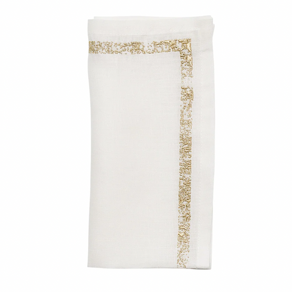 The Kim Seybert Impression White & Gold Napkin Set of 4 features neatly folded white linen napkins accented with decorative gold metallic stitching along two edges, displayed against a plain white background.