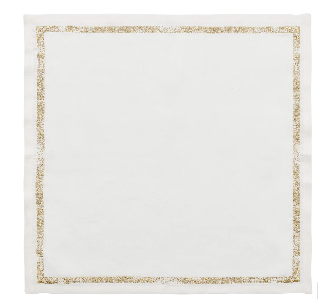 The Kim Seybert Impression White & Gold Napkin Set of 4 features white linen napkins with an elegant gold metallic stitched border, shown flat against a white background.
