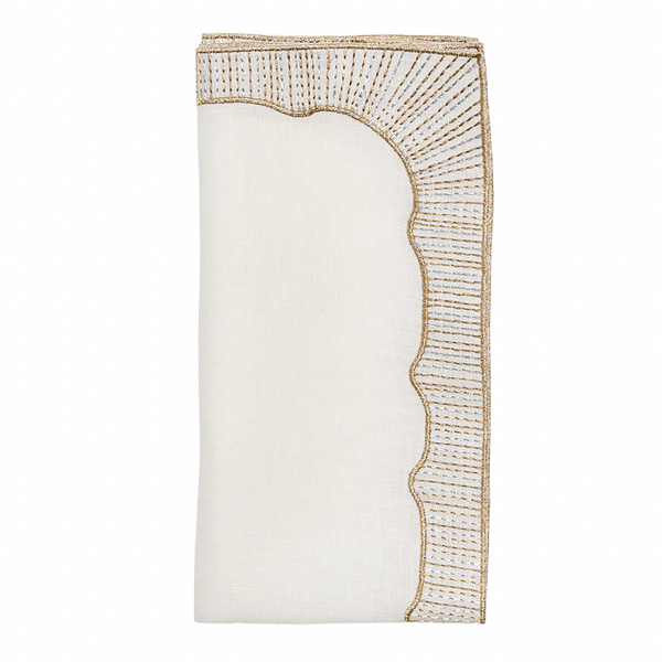 The Frame White, Gold & Silver Napkin Set of 4 by Kim Seybert features folded white linen napkins with scalloped edges and intricate gold and silver embroidery—ideal for sophisticated, elegant table settings.