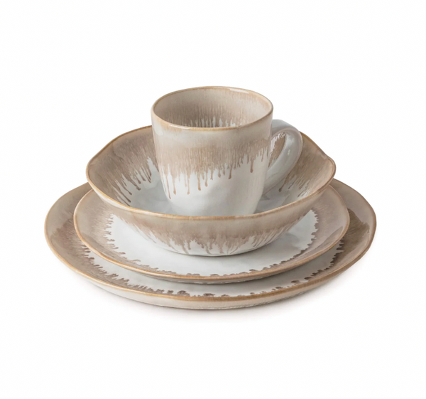 The Simon Pearce Burlington Dinnerware Bluff set includes a plate, salad plate, bowl, and mug, each crafted from ceramic with beige and white glaze and a rustic drip edge for an organic look.