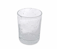A clear stemless Bellini Glassware by Mariposa, featuring small air bubbles throughout its surface, stands empty on a white background. This elegant Italian glass is dishwasher safe.