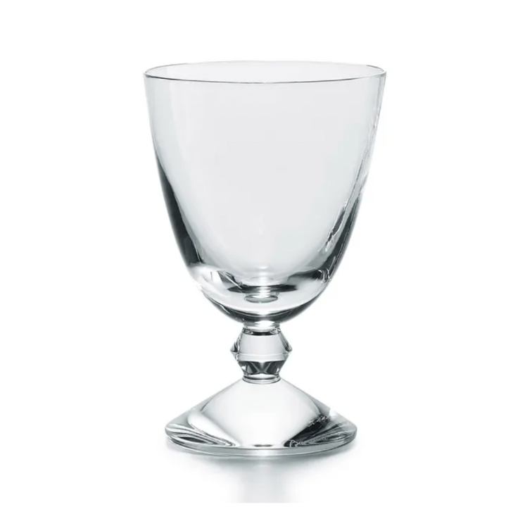 The Baccarat Vega Water Glass features a clear, wide-bowled goblet artfully set on an inverted glass base, standing out as a luxurious and unique piece—ideal for those who appreciate fine glassware.