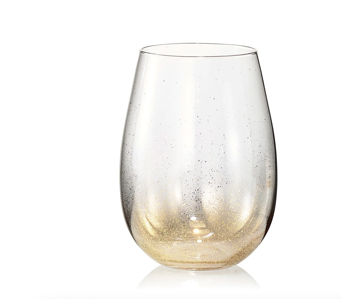 The Kim Seybert Orion Gold Barware Set of 4 includes clear stemless wine glasses with gold flecks and a hand-sprayed gold shimmer gradient at the base, perfect for elegant occasions.
