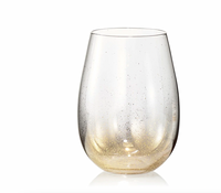 The Kim Seybert Orion Gold Barware Set of 4 includes clear stemless wine glasses with gold flecks and a hand-sprayed gold shimmer gradient at the base, perfect for elegant occasions.