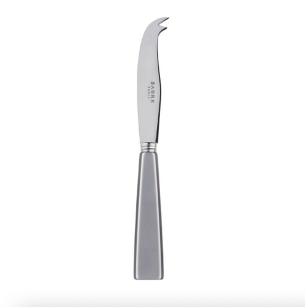 The Sabre Icone Large Cheese Knife in Light Grey features a flat handle, short curved blade, and forked tip—ideal for slicing and serving cheese. Crafted from stainless steel, it’s part of the stylish Icone Flatware collection.