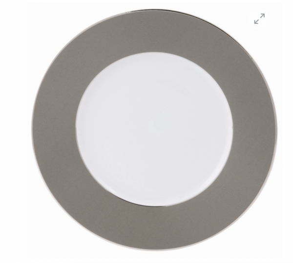 The Philippe Deshoulieres BIA Metallic Presentation Plate is round with a wide metallic gray rim and plain white center, accented by subtle platinum details and shown from above on a white background.