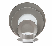 The Philippe Deshoulieres BIA Metallic Presentation Plate is a formal Limoges porcelain piece featuring a sleek gray and white design with silver rims, offering an elegant touch to your dinnerware collection.