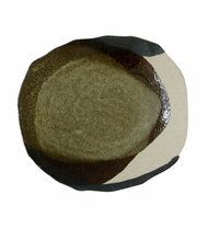 The Wabi Seidou Dinnerware by Jars is a round ceramic plate with an uneven edge, showcasing an abstract design in olive green, dark brown, and beige. The unique piece is photographed from above on a white background.