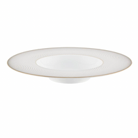 The Raynaud Oskar Dinnerware soup plate features white Limoges porcelain with a wide, flat rim accented by subtle gold lines and a fine gold edge. Its recessed center is perfect for soups or pasta, making it a refined addition to your table.