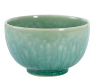 The Tourron Dinnerware Jade bowl by Jars - Rosenthal features a textured light green ceramic finish, a darker rim, and an elegant round shape—showcasing timeless style.