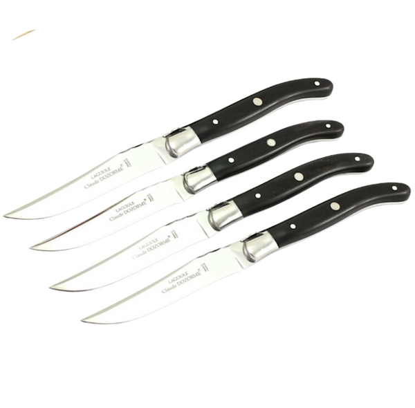 Four stainless steel knives with black handles and silver rivets from the Claude Dozorme Laguiole Steak Knives Set are aligned on a white background, highlighting their modern design and classic French craftsmanship.