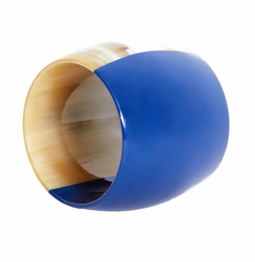 The Horn Napkin Ring Set of 4 by Von Gern Home features a natural horn interior and a glossy blue exterior—ideal for those who appreciate unique design and stylish table accessories.