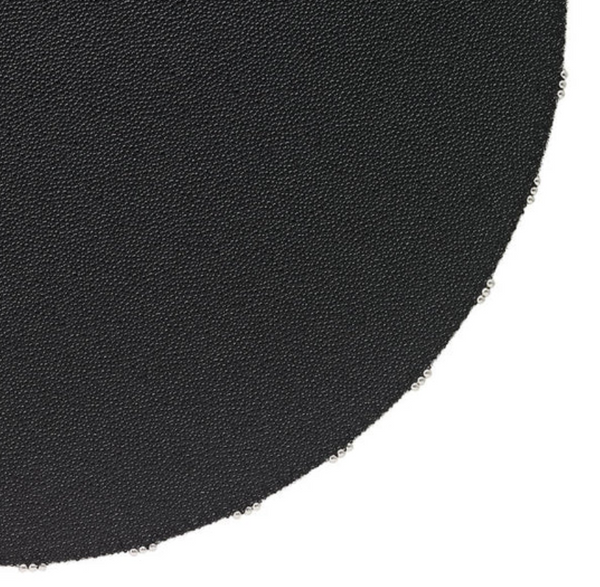 Close-up of Bodrum's Charm Placemat Black Set of 4, showing round black placemats with evenly spaced metal rings along the edge, against a white background.