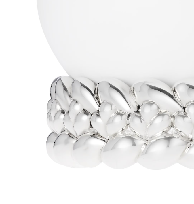 A close-up of the Babylone Vase by Christofle, handmade in France, featuring white porcelain on a silver-plated base with a rounded leaf or petal pattern.