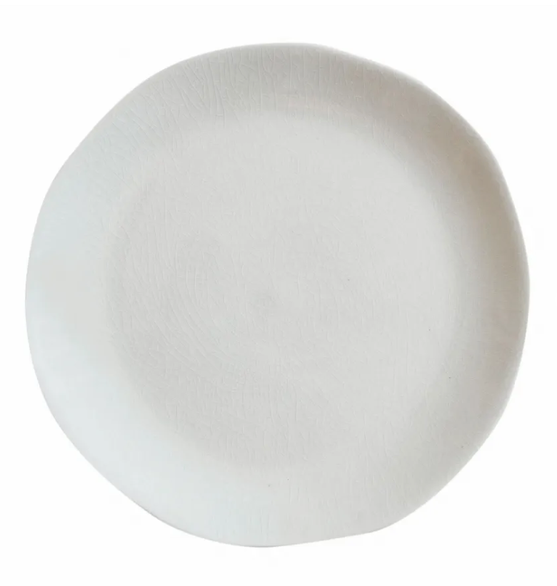 The Maguelone Dinnerware Quartz plate by Jars - Rosenthal features a plain, round, white ceramic design with an organic rim, capturing Mediterranean charm when viewed from above on a white background.
