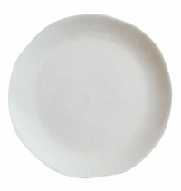 The Maguelone Dinnerware Quartz plate by Jars - Rosenthal features a plain, round, white ceramic design with an organic rim, capturing Mediterranean charm when viewed from above on a white background.