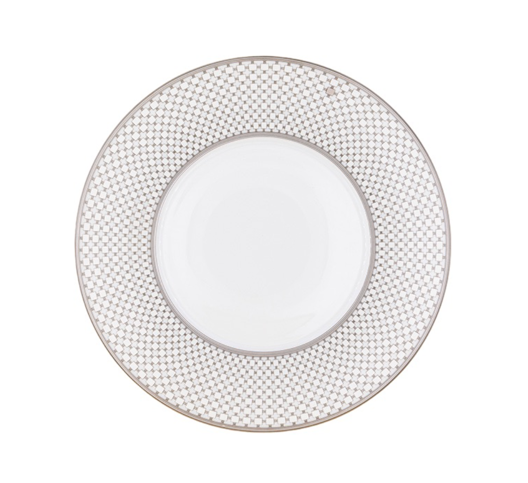 The Home Platinum Dinnerware by Robert Haviland & C. Parlon features a subtle interlocking geometric rim and a slim silver band—an elegant addition to any table.