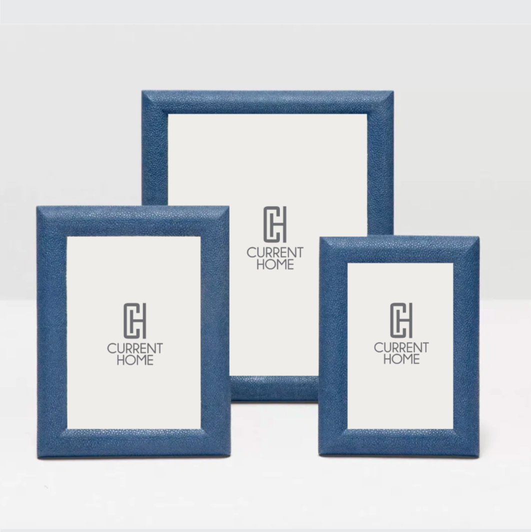 Three navy Oxford Faux Shagreen Frames by Pigeon and Poodle of varying sizes stand upright, each displaying a CURRENT HOME placeholder with a simple logo centered.