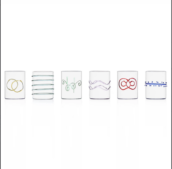 The Ichendorf Milano Deco Arlecchino Water Glass Set of 6 features clear glasses, each adorned with a unique pattern—rings, lines, swirls, waves, loops, and dots—adding style to your table.