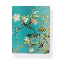 Louis Vuitton: A Perfume Atlas by W.W. Norton Company—a perfumery book with white flowers and green branches on a bright blue cover, capturing the beauty of fragrance ingredients.