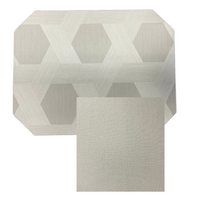 The Julian Mejia Reversible Cut Corner Placemat Set of 4 in Sisal features a modern rectangular design and subtle pattern, perfect for stylish table decor.