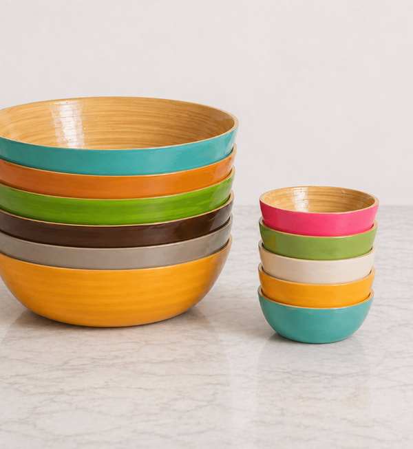 Two stacks of Albert L Bamboo Classic - Mini Dip Bowls with glossy, food-safe finishes sit on a marble countertop. These durable bamboo bowls are perfect for stylish and practical everyday use.